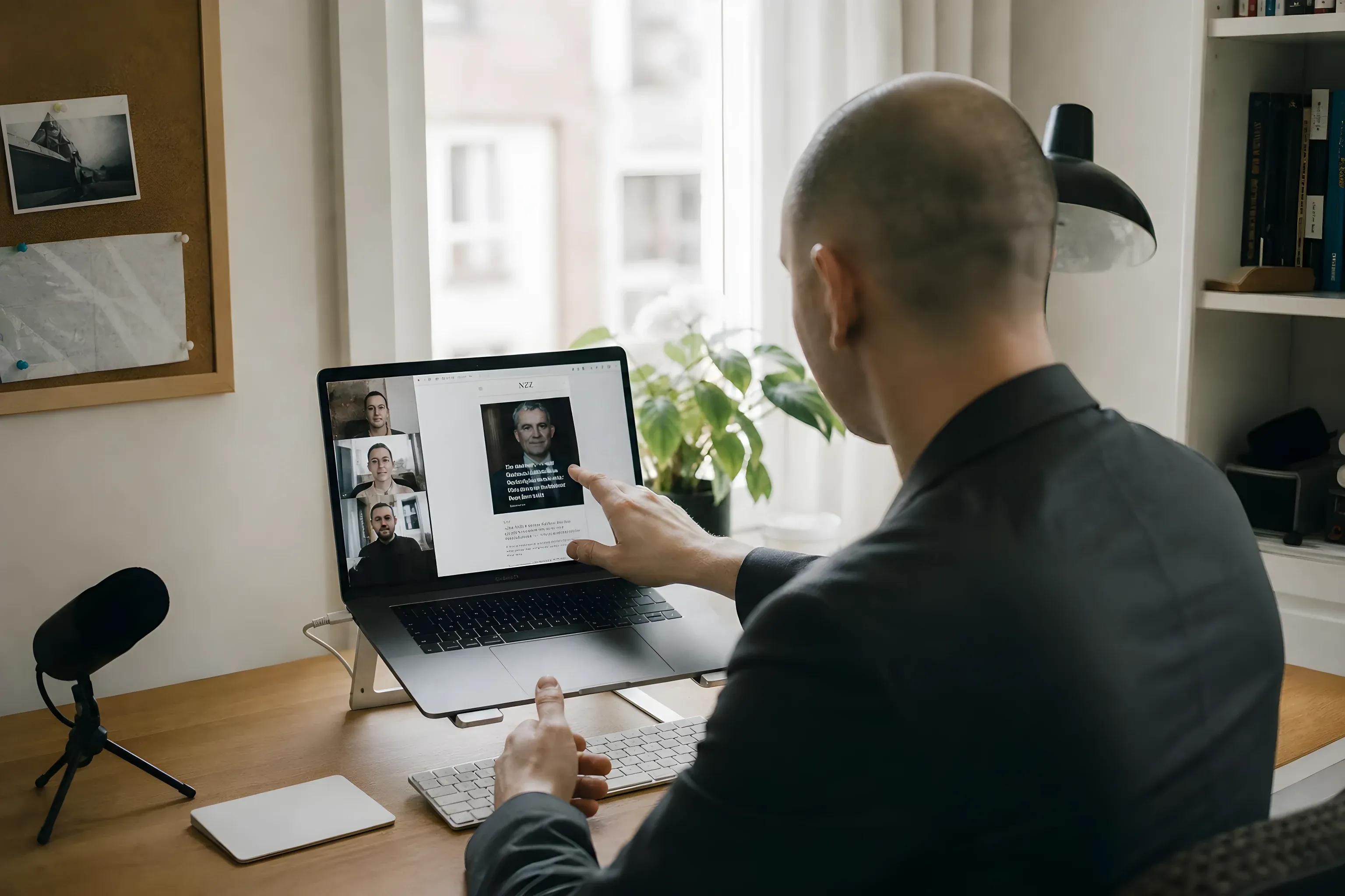 Me on a video call with the newsroom, pointing at the new NZZ front page on screen